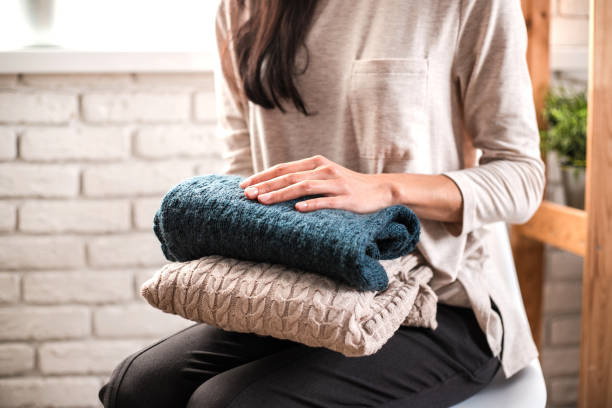 istock Woman's hands holding knitted clothes. Close up. 1191414394