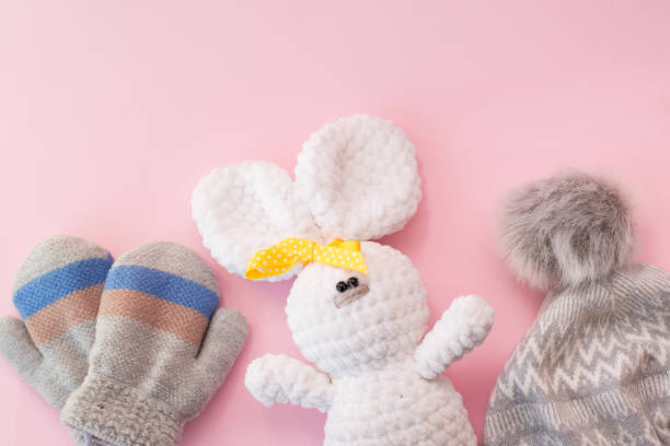 istock Baby winter clothes and toy on pink background, copy space 1191415321