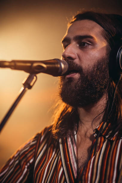 istock Man singer singing in microphone 1191415928