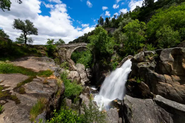 Photo of View of the Mizarela Bridge with a waterfall at the Peneda Geres National Park