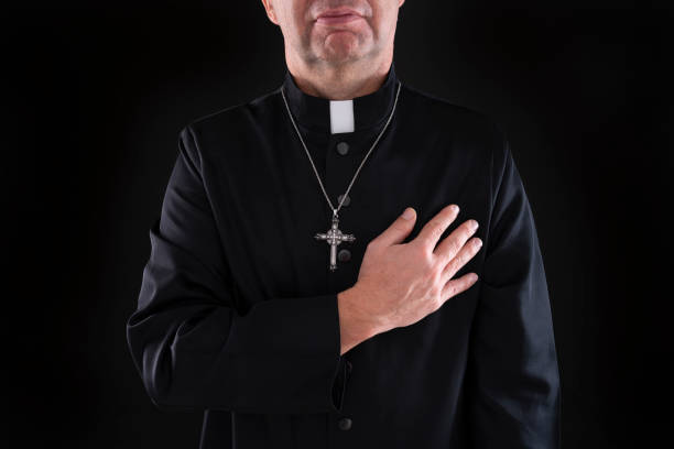 istock Priest hand in heart as a honesty gesture in dark 1191417255