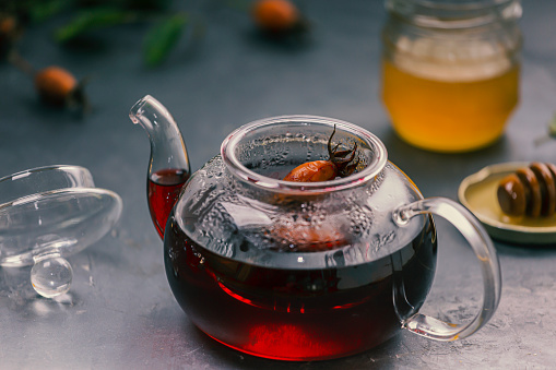 Tea from rose hips in a teapot on the table.