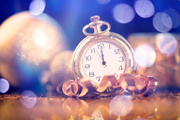 istock New Year's at midnight - Old clock with holiday lights 1191417449
