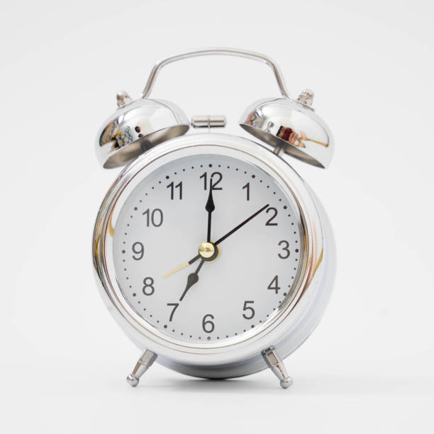 istock Silver retro alarm clock on isolated background 1191417729