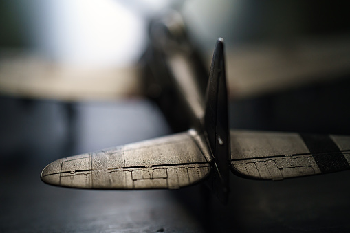 Plastic model WW2 plane on dark background.