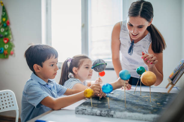 istock Teacher and two children on class in private elementary school 1191418615