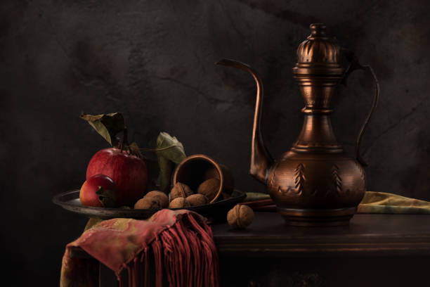 istock Still life with a copper jug, apples and nuts on a wooden table 1191418632
