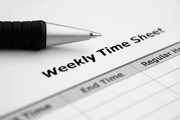 Close up of weekly time sheet with pen stock photo
