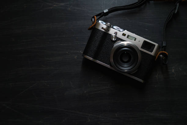 istock Old style digital cameras isolated on dark background 1191419852