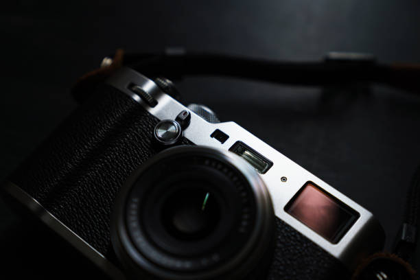 istock Old style digital cameras isolated on dark background 1191419939