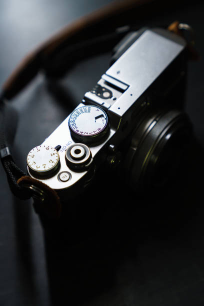 istock Old style digital cameras isolated on dark background 1191419964