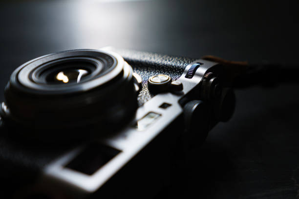 istock Old style digital cameras isolated on dark background 1191420004