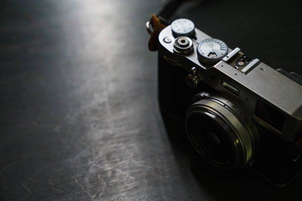 istock Old style digital cameras isolated on dark background 1191420101