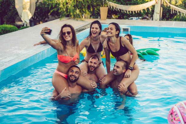 istock Selfie with friends at a poolside party 1191420200