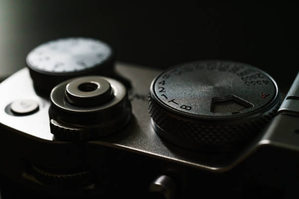 istock Old style digital cameras isolated on dark background 1191420209
