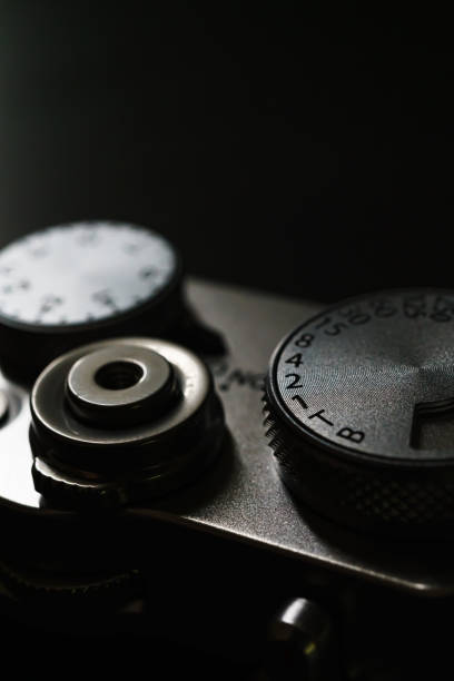 istock Old style digital cameras isolated on dark background 1191420218