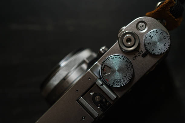 istock Old style digital cameras isolated on dark background 1191420231