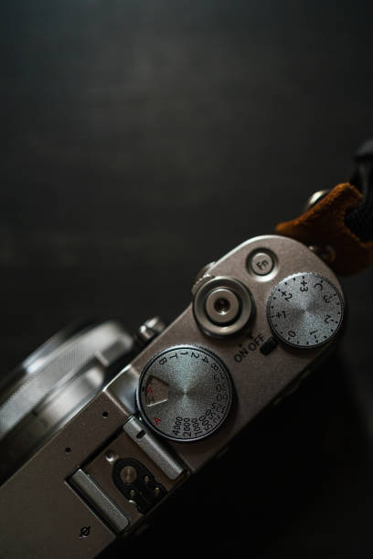 istock Old style digital cameras isolated on dark background 1191420245