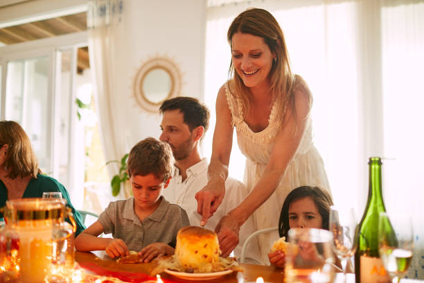 istock A mother is cutting and serving some cake at Christmas dinner. 1191421257
