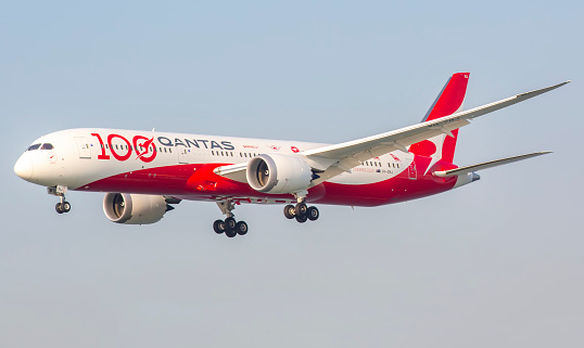 This image is of a Qantas Boeing 787-9 painted in the brand new 100-year livery. This aircraft is coming from Sydney. Qantas is the flag carrier of Australia and its largest airline by fleet size, international flights, and international destinations. It is the third oldest airline in the world, after KLM and Avianca, having been founded in November 1920; it began international passenger flights in May 1935.