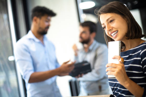 istock Young woman smiling while holding tile samples in her hand 1191425138