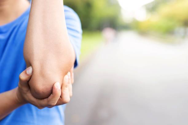 istock Men with elbow pain in the park 1191425412