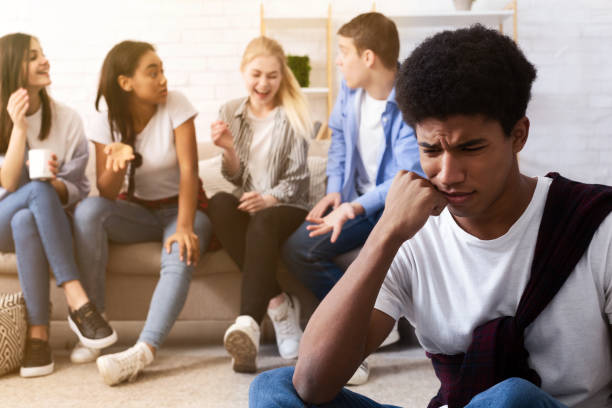 istock Bullying concept. Sad guy avoiding bad friends 1191427941