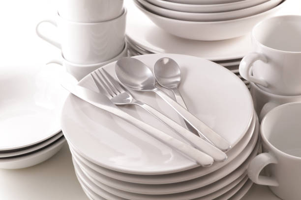 pile of plates empty with mug and bowl isolated on white background