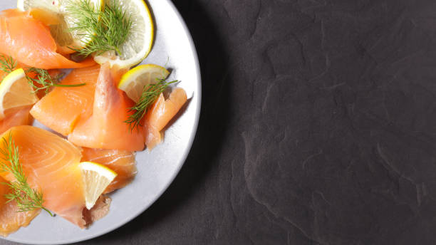 istock smoked salmon with lemon and dill, top view 1191428315