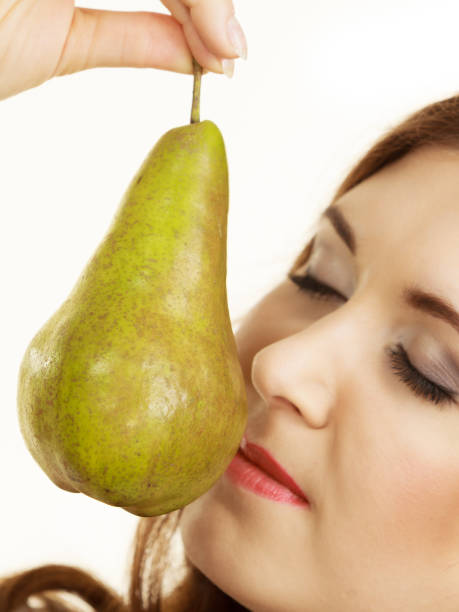 Woman holding pear fruit. Healthy diet.
