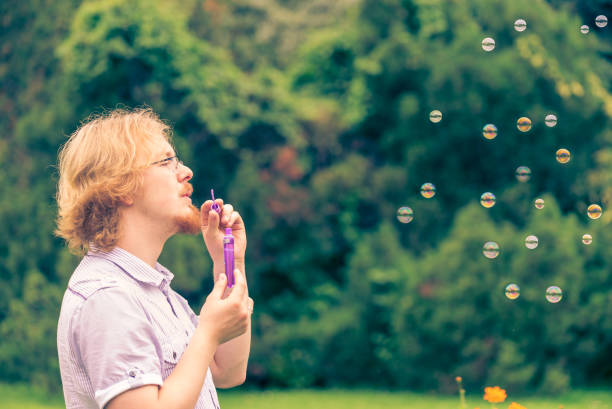 istock Man blowing soap bubbles outdoor 1191428433
