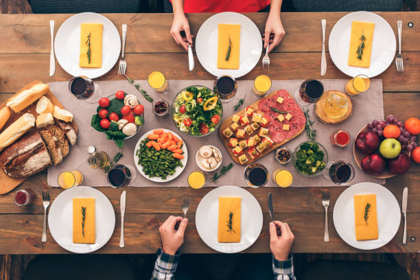 istock Two people sitting at home behind table with food 1191429903