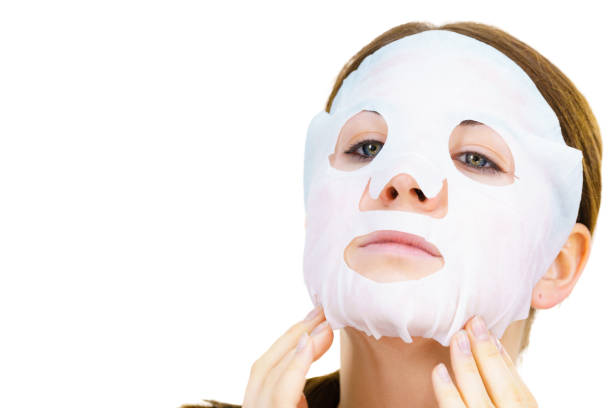 istock Woman applying sheet mask on face 1191430178