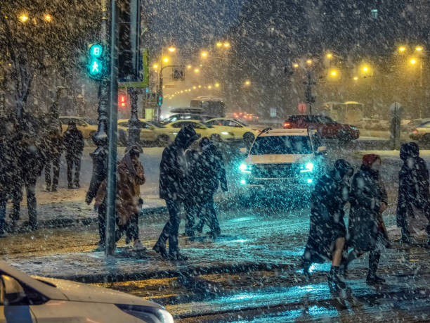 istock Falling snow in the night city. Traffic jams 1191431092