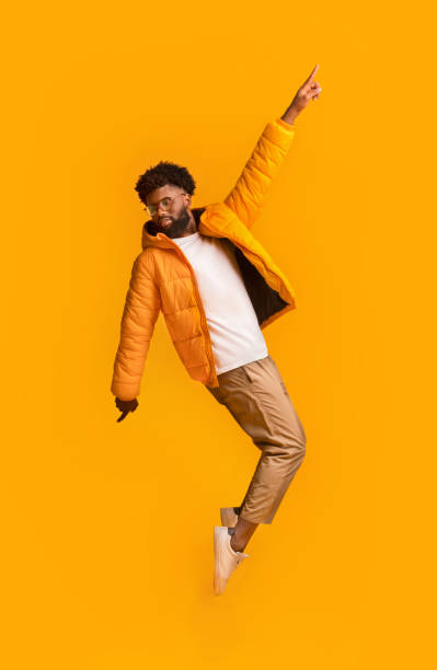 istock Carefree winter black guy standing on his toes, leaning backward 1191431149