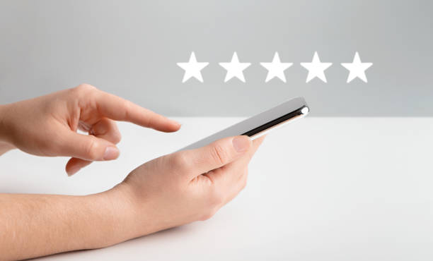 istock Woman evaluating mobile app on cellphone over gray 1191431292