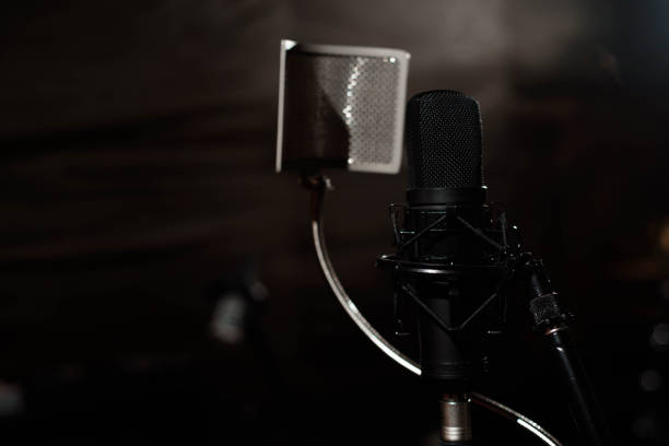 istock Black vocal microphone is stand in sound recording studio room u 1191431793