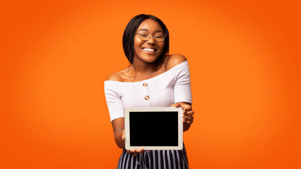 istock Afro Girl Showing Digital Tablet Screen Standing In Studio, Panorama 1191431937
