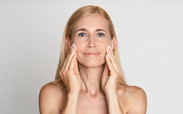 istock Middle-aged woman removing make up with cotton pads 1191433019