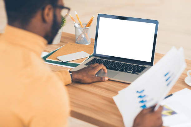 istock African american manager typing on lapop holding report 1191433322