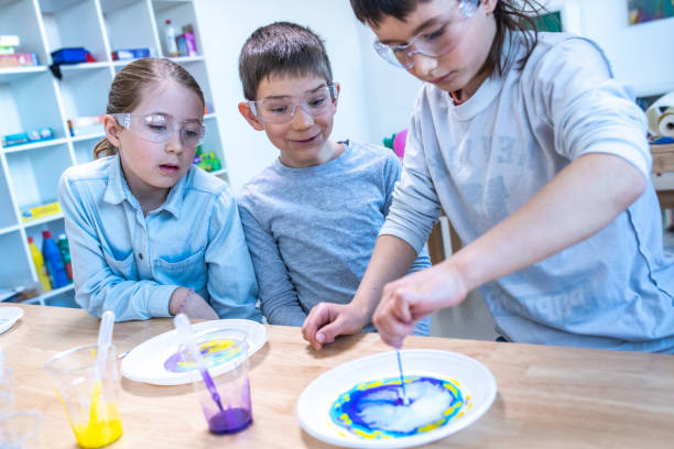 istock Students doing colour changing milk experiment in the laboratory 1191433388