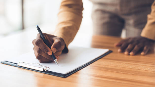 istock Closeup of black manager taking notes to notepad 1191433629