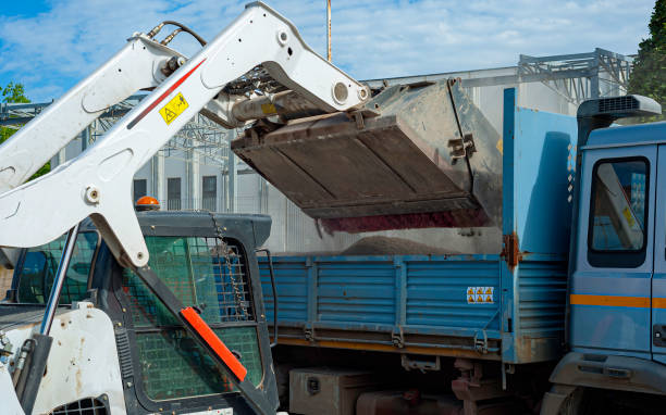 istock Sweeper attachments mini excavator. The sweeper sweeps, collects and dumps dirt and debris. 1191434361