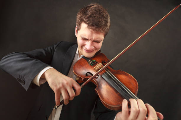 istock Man playing violin showing emotions and expressions 1191434555