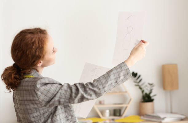 istock Paying attention. Designer looking at new sketches 1191435012