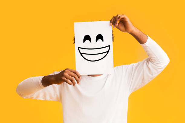 istock African american man holding paper with smiley face 1191436139