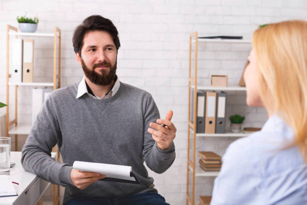 istock Friendly psychotherapist talking to young female patient 1191436571