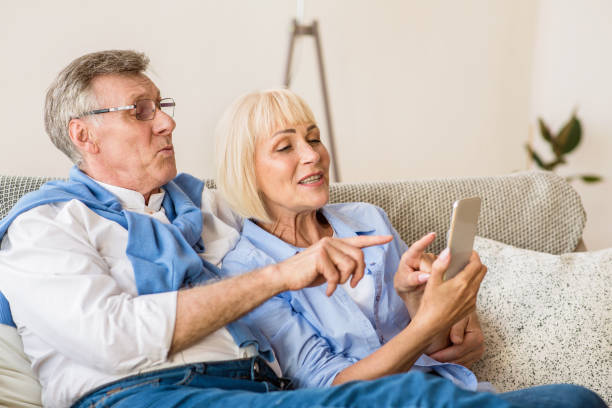 istock Modern senior couple making video call on cellphone 1191437534