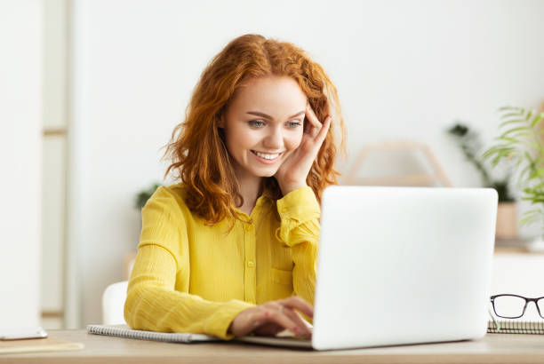 istock Successful businesswoman working on laptop in light office 1191437714