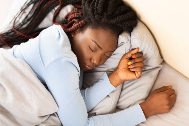 istock Afro Woman Sleeping Lying In Bed At Home, Above View 1191437845